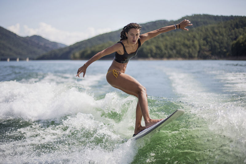 Girl surfing in lake
