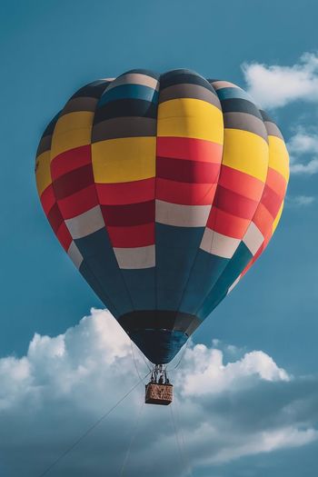 Low angle view of hot air balloon flying against sky