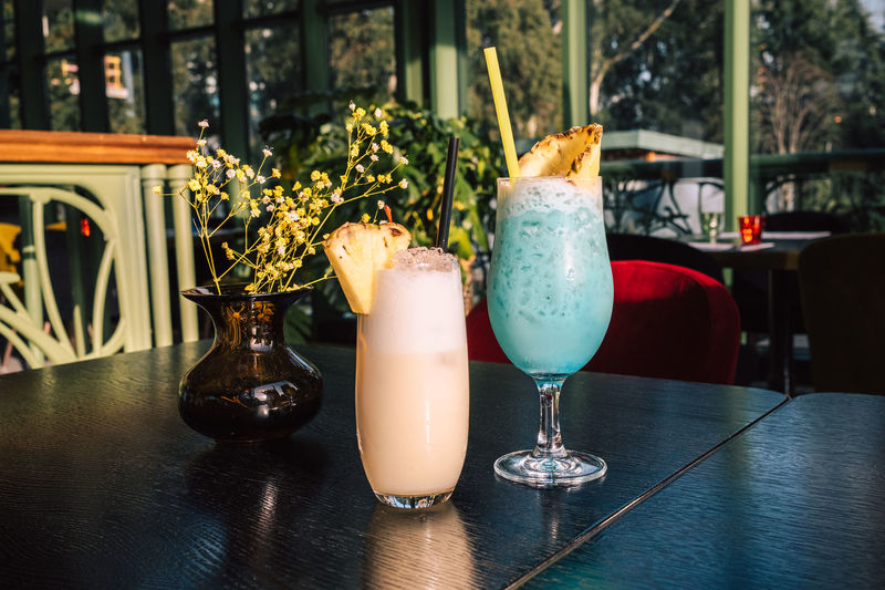 Tropical cocktails with pineapple and straw in glasses. pina colada. blue curacao. 