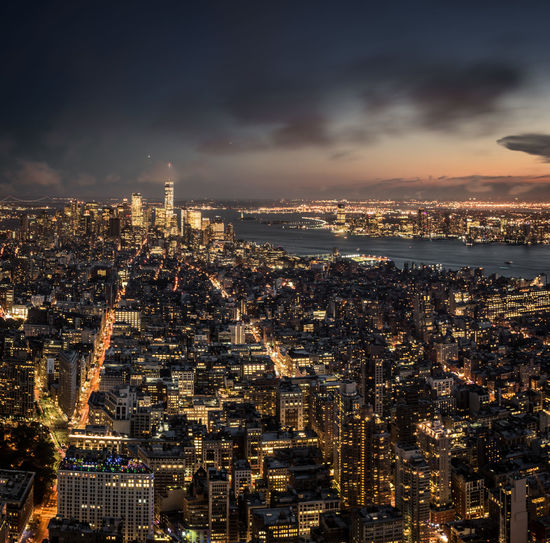 Illuminated cityscape against sky