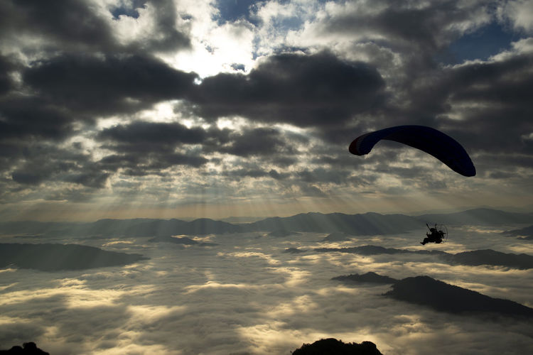 High angle view of man paragliding in sky
