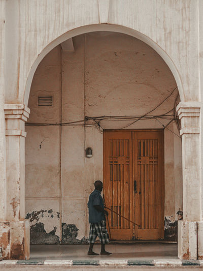 Rear view of woman walking in historic building