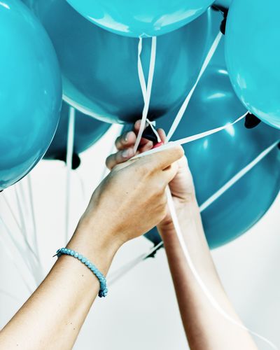 Cropped image of friends holding balloons