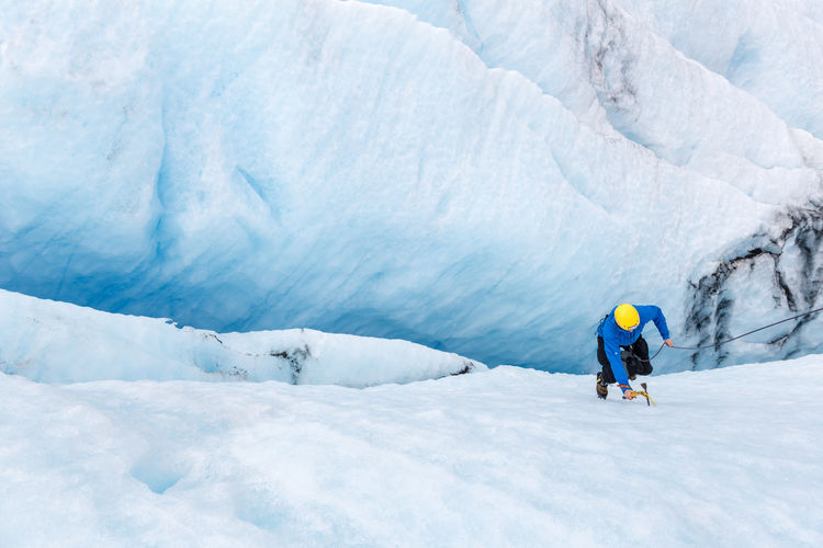 High angle view of person climbing on crevasse