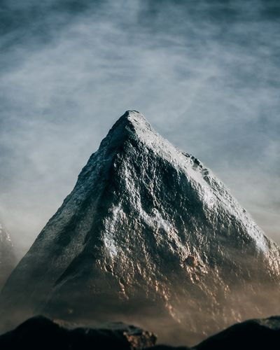Low angle view of snowcapped mountain against sky