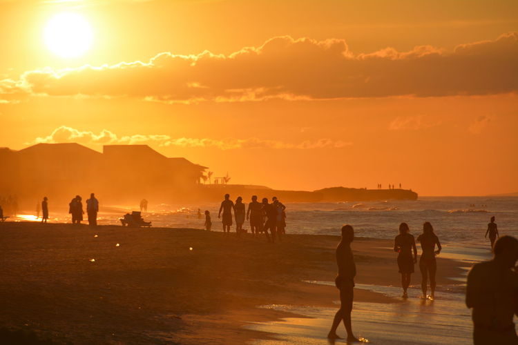 People on beach at sunset