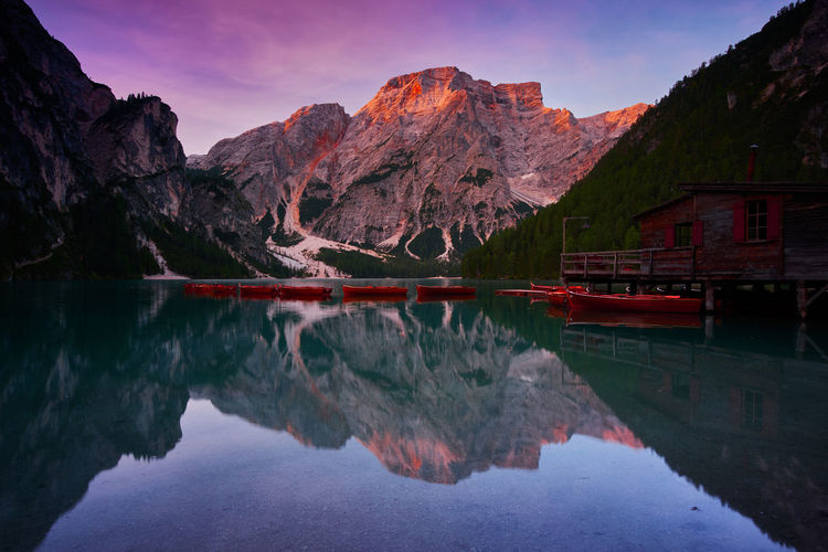 Scenic view of lake by mountains against sky