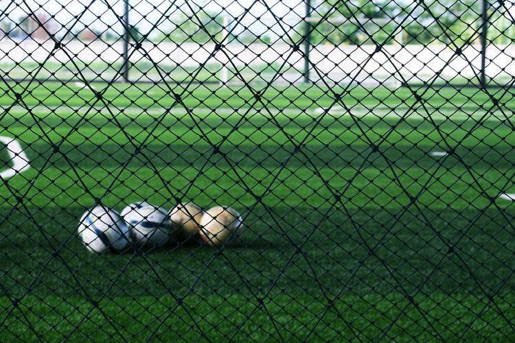 Field seen through chainlink fence snd blur soccer football 