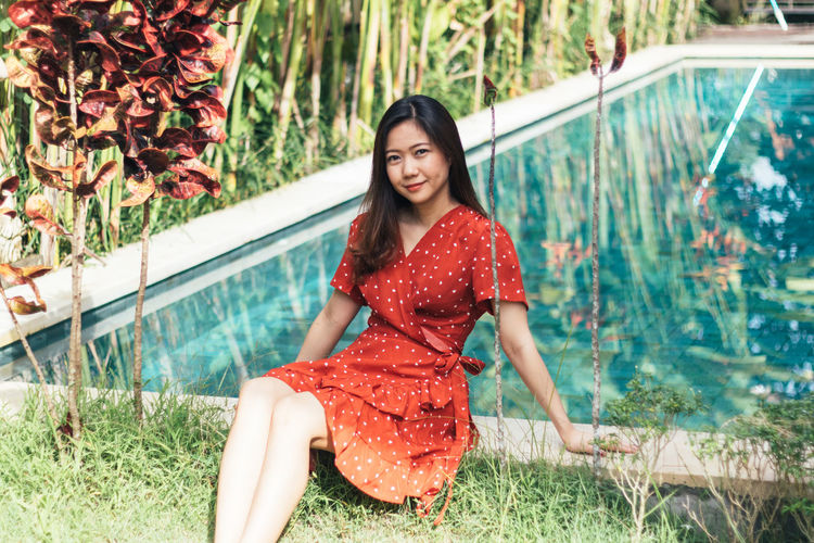 Pretty asian woman is relaxing in the pool villa.
