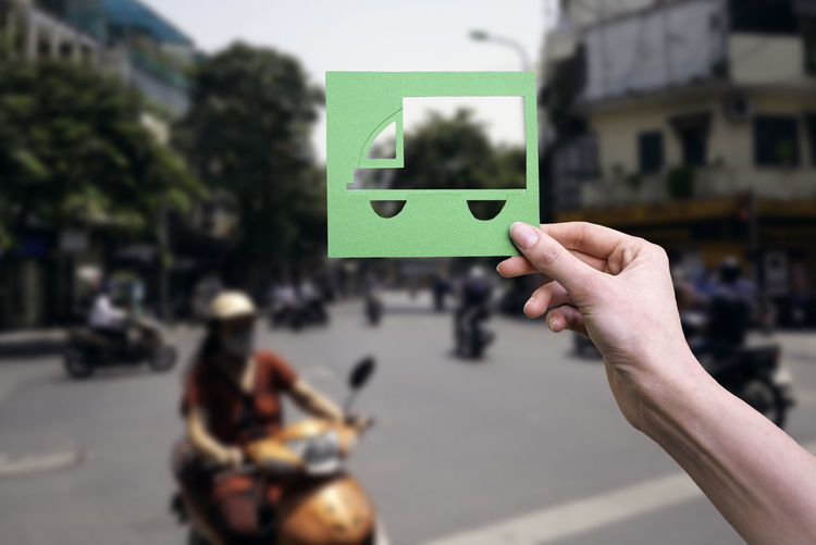 Hand holds green logistics symbol on hanoi vietnam