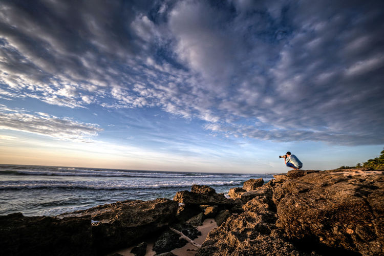 Scenic view of sea against cloudy sky