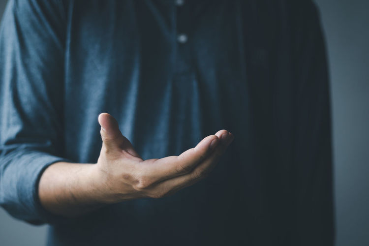 The man is spreading his hands at the level of his chest. suitable for making products
