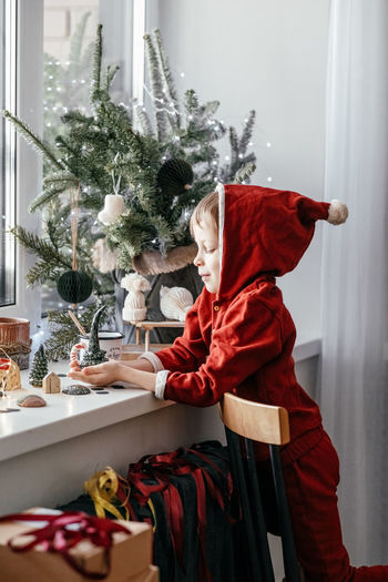 Portrait of cute girl sitting on sofa at home