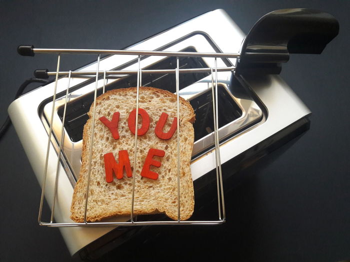 High angle view of a slice of bread on a toaster and the words you and me 