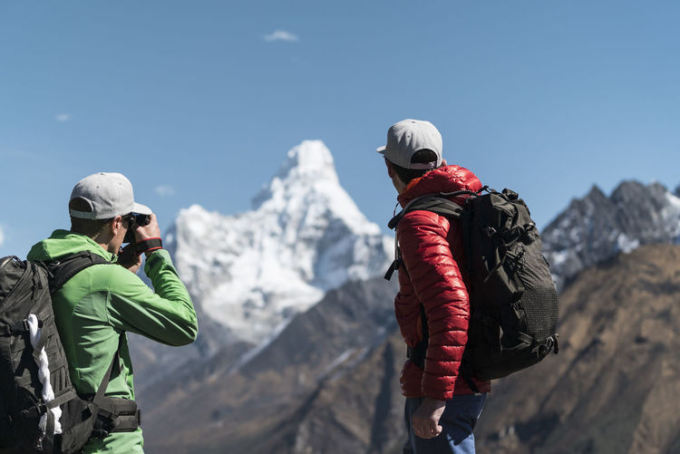 Two men looking out at ama dablam, khumbu, nepal