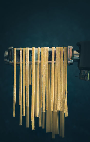 Close-up of raw pasta on equipment