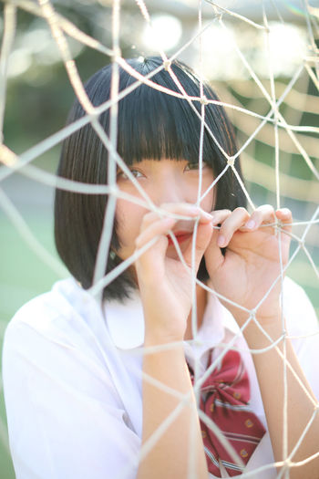 Close-up portrait of girl holding net