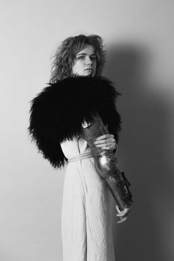 Attractive woman with metal armour in studio monochrome portrait picture