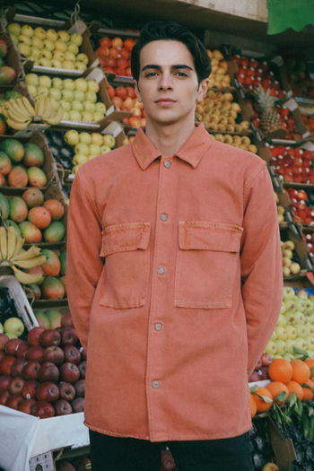Portrait of young boy standing in market