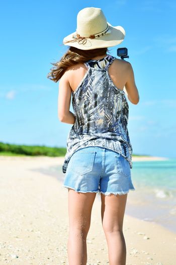 Rear view of woman wearing hat at beach