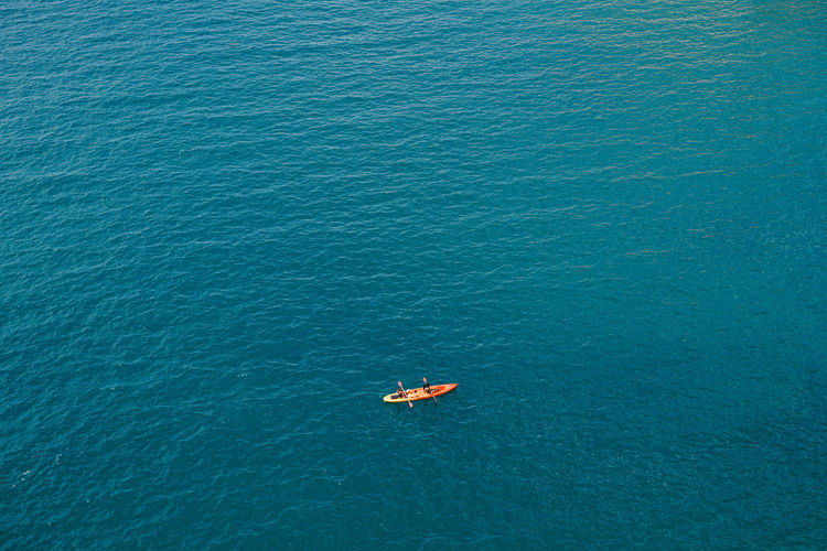 High angle view of person floating on sea