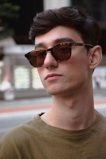 Portrait of young man wearing sunglasses on the street, são paulo, brazil