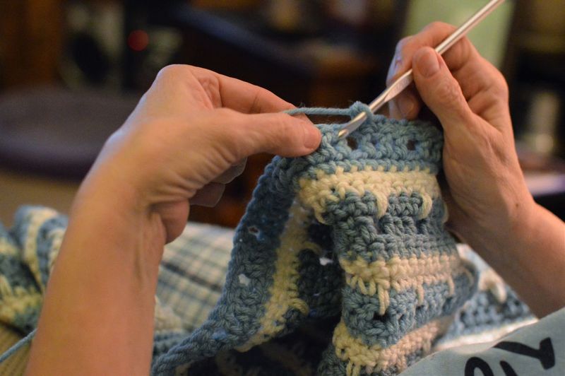 Close-up of hands crocheting at home