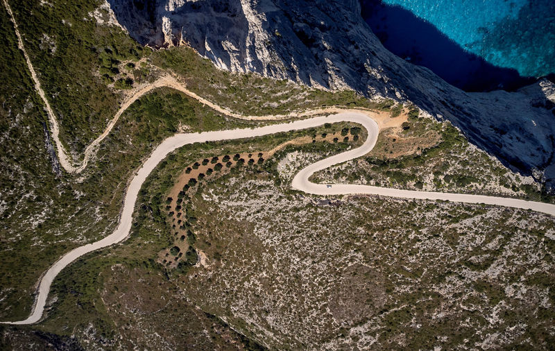 Aerial view of winding road by sea