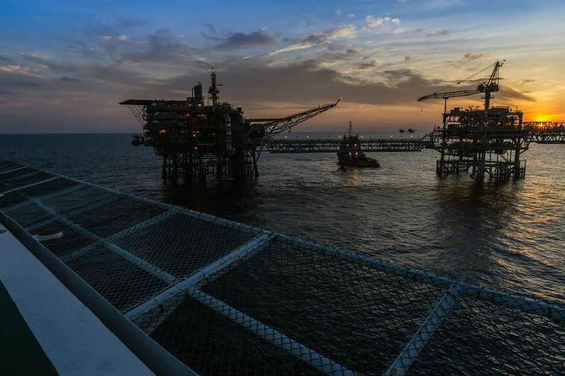 Sunset at oil field viewed from a helideck of a construction work barge at offshore oil fieldkuala