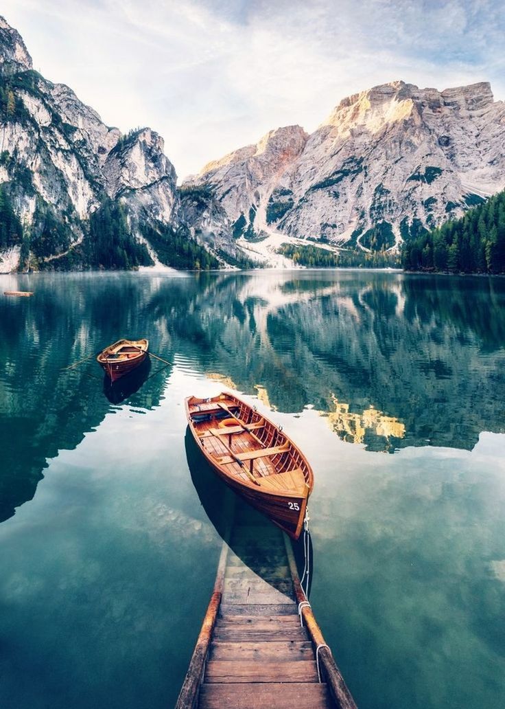 water, mountain, lake, scenics - nature, nautical vessel, beauty in nature, reflection, tranquility, tranquil scene, mountain range, nature, mode of transportation, transportation, sky, non-urban scene, cloud - sky, day, wood - material, no people, outdoors, rowboat, formation, snowcapped mountain