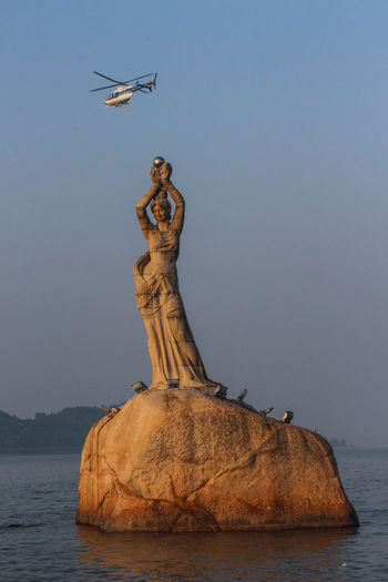 Statue on lake
