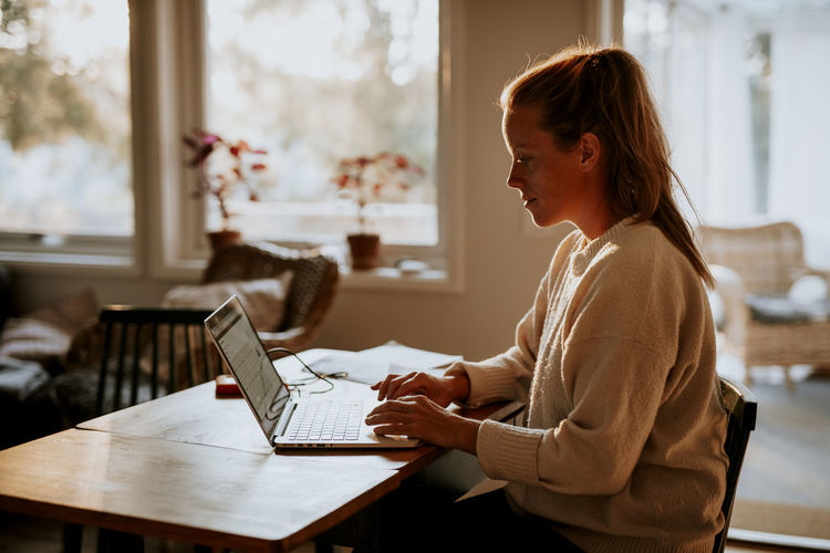 Woman using laptop at home