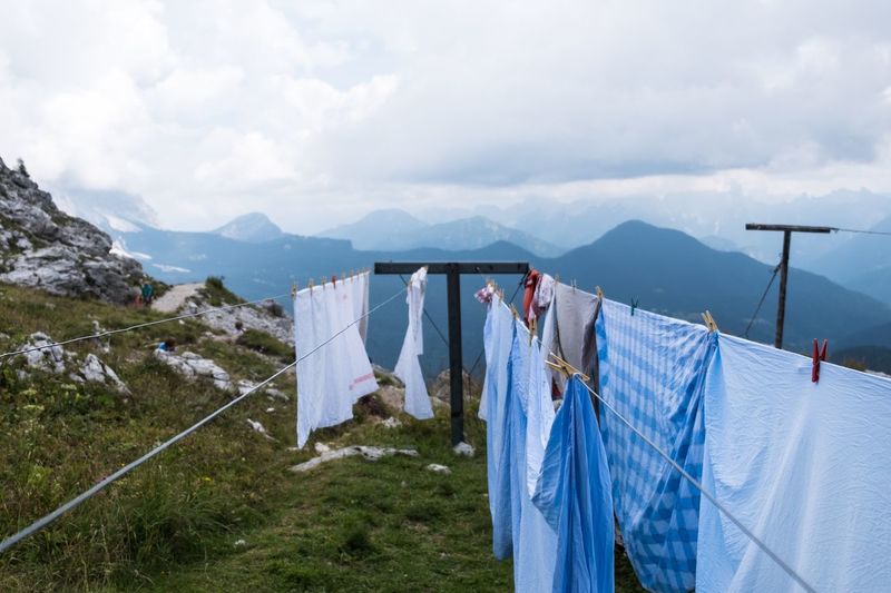 Clothes drying on clotheslines against sky