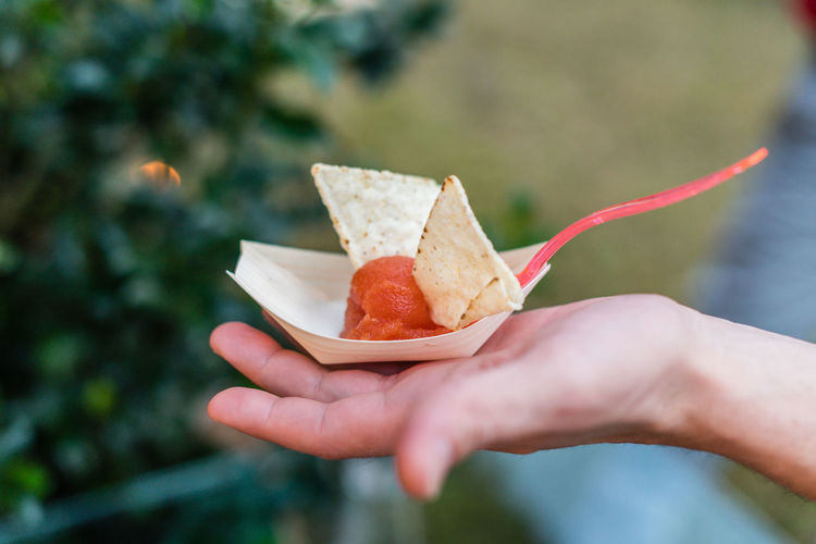 Cropped image of hand holding snack