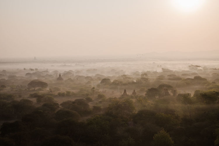Scenic view of landscape against sky at sunrise