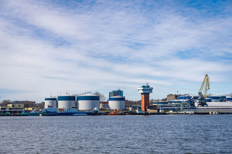 Terminal of cargo international seaport of klaipeda, lithuania. cargo ship, loading and fuel tanks.