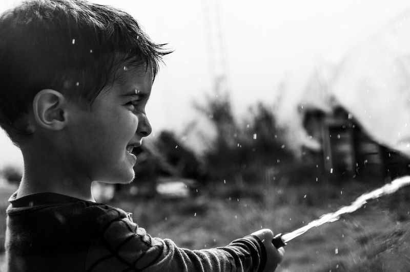 Cute little boy is playing with water