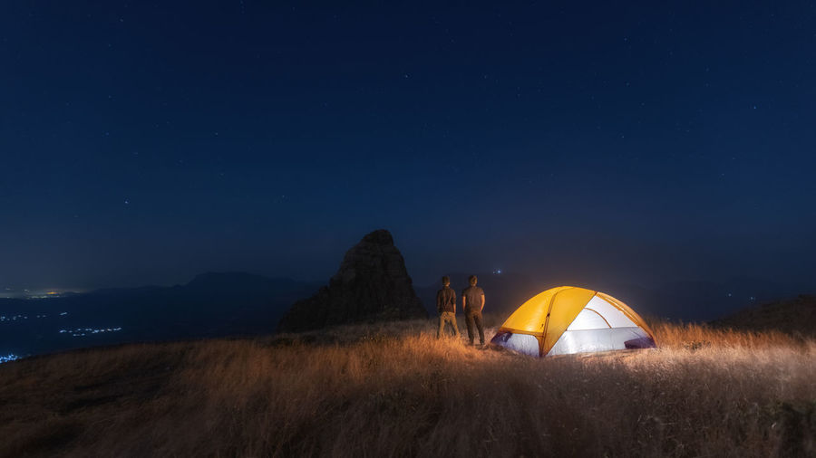 Tent on field against sky at night
