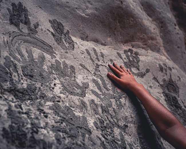 High angle view of hand on rock