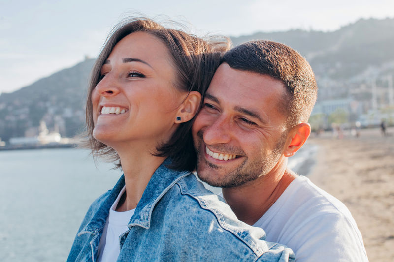 Happy portrait couple in love on the beach. diverse couple on summer vacation. 