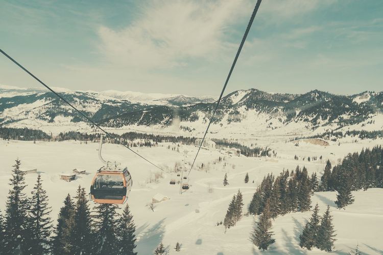 Overhead cable car against mountains during winter