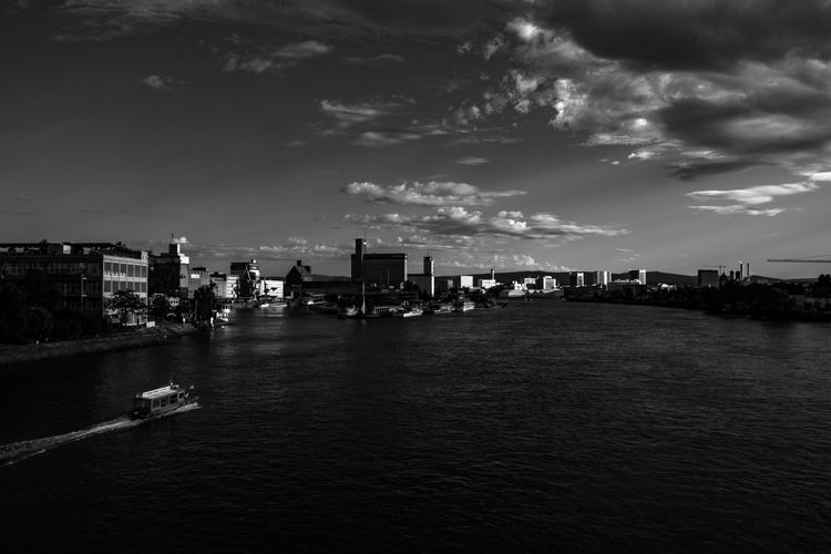Boat in rhine river at weil am rhein against sky