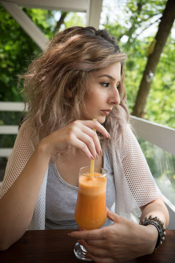 Close-up portrait of woman drinking juice
