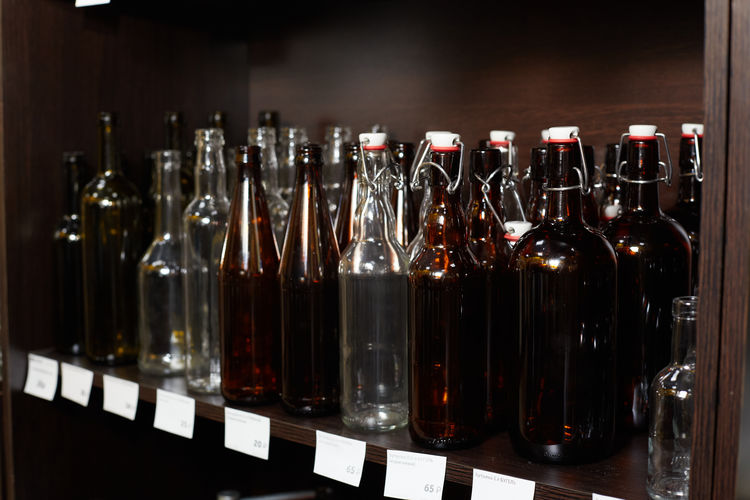 Display case with empty glass dark bottles