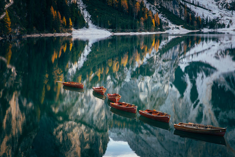 Boats in lake against mountains