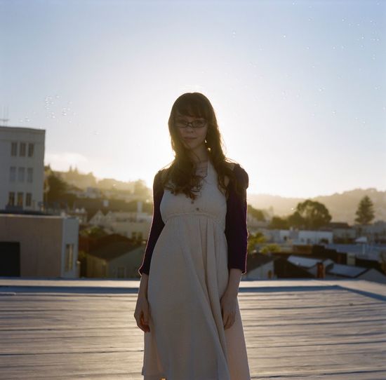 Portrait of a content young woman standing outdoors