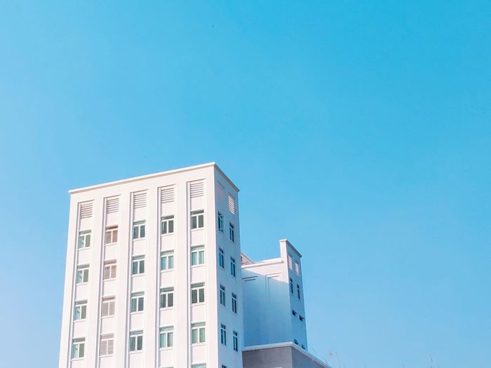 Low angle view of building against clear blue sky