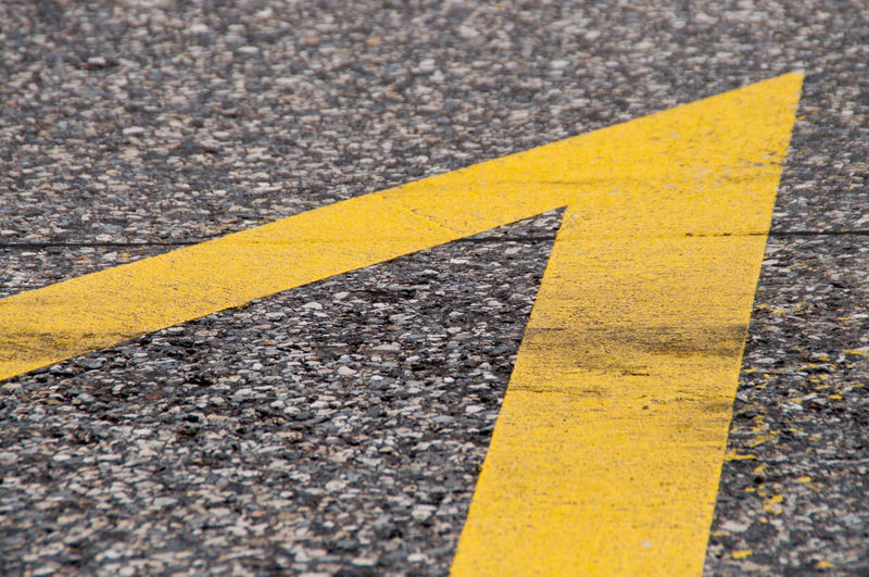 Close-up of yellow road marking on city street