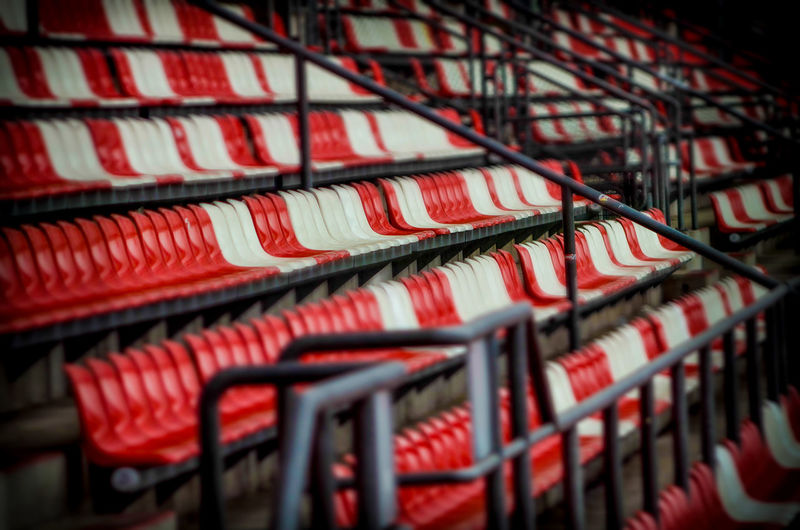 Empty red and white seats at soccer stadium
