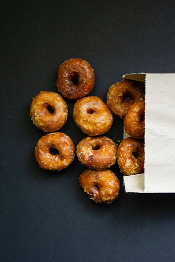 Directly above shot of donuts against black background